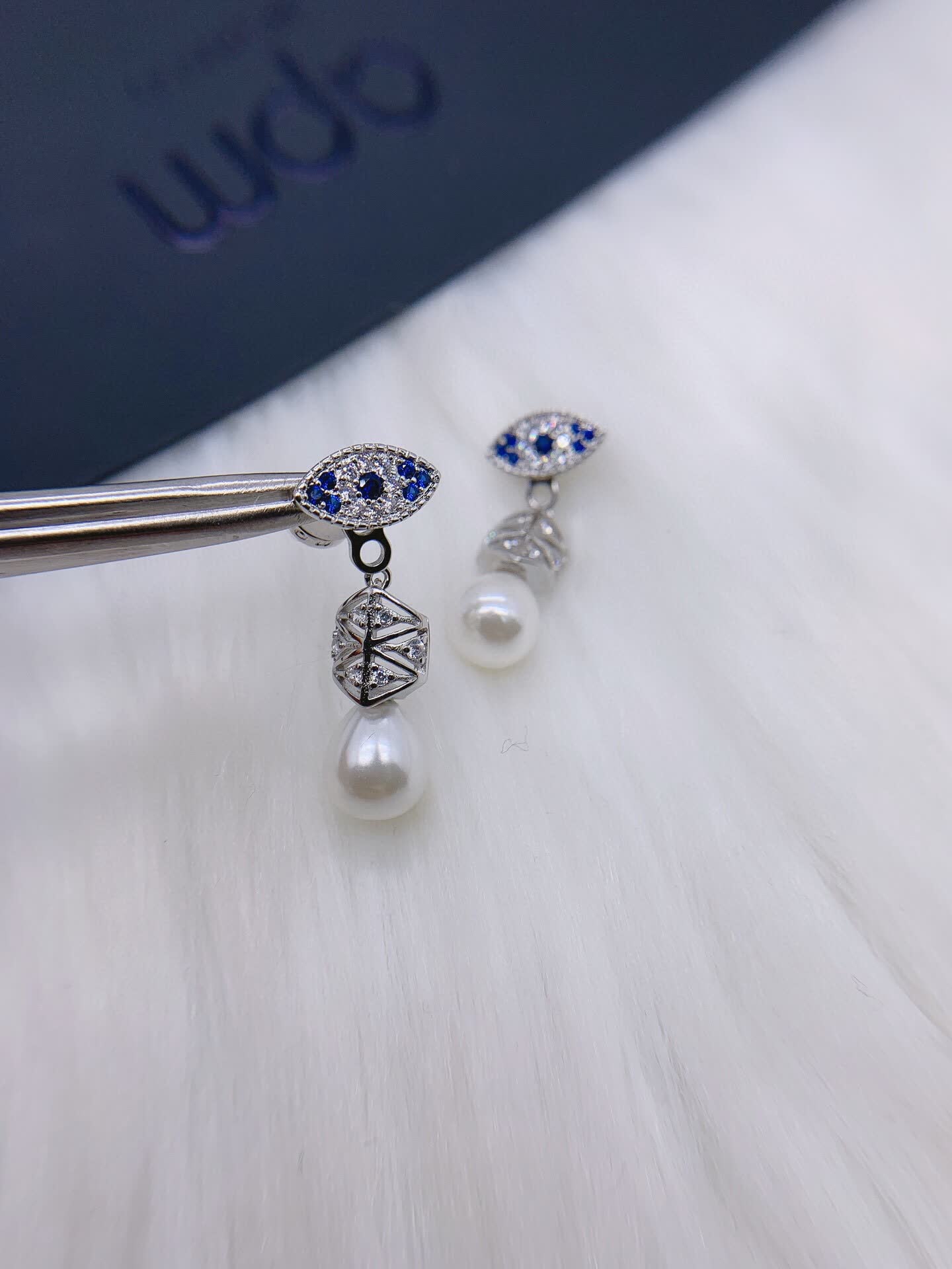 APM Monaco Elegant Pearl and Sapphire Eye Stud Earrings